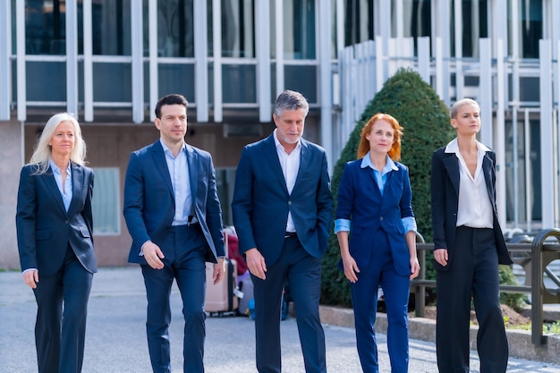 executives having fun five professionals laughing walking commercial buildings area 242111 28440